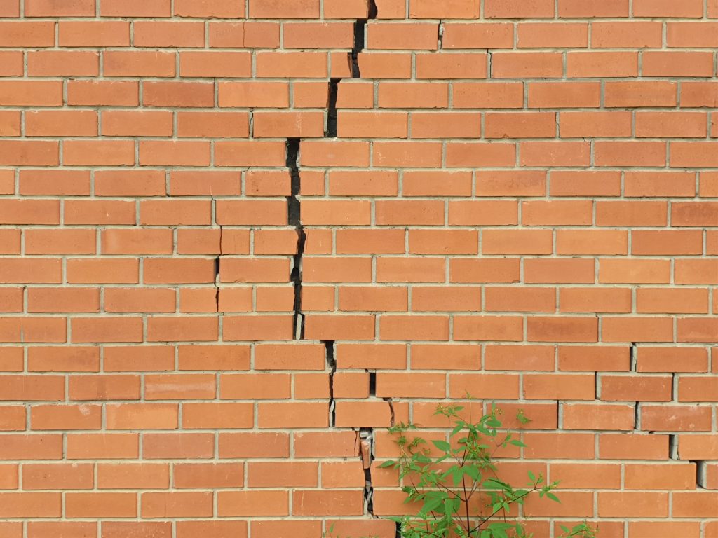 Cracked brick wall. Broken brick wall